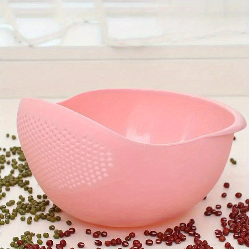Pink colander with green and red beans on a white surface