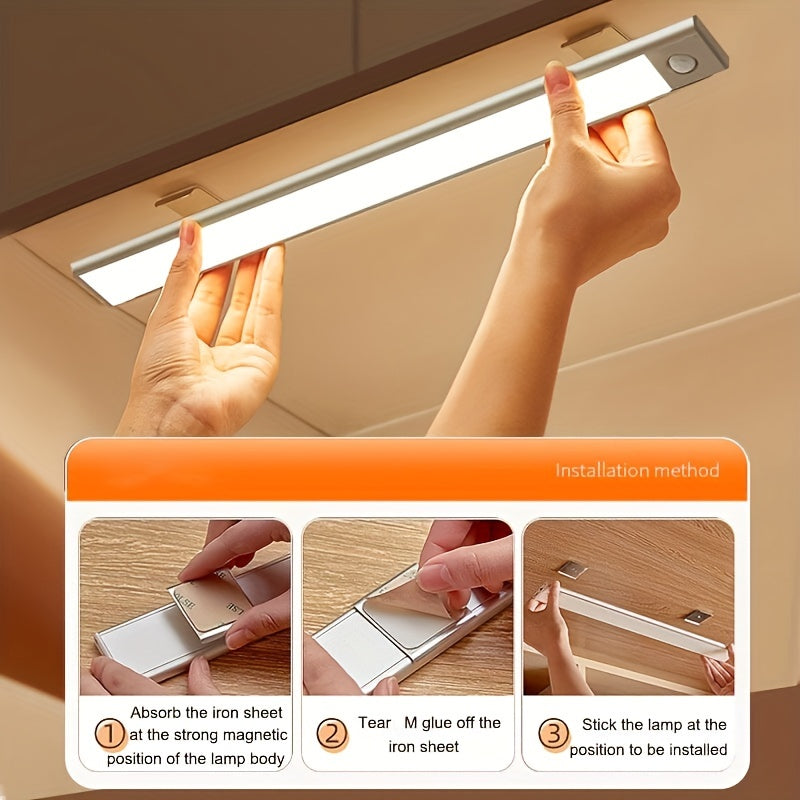 Under-cabinet light strip with installation instructions on a wooden surface