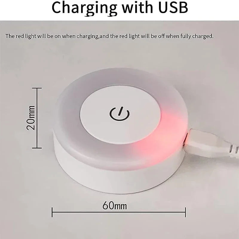 Wireless charging pad with USB cable and red light indicator on a gray background