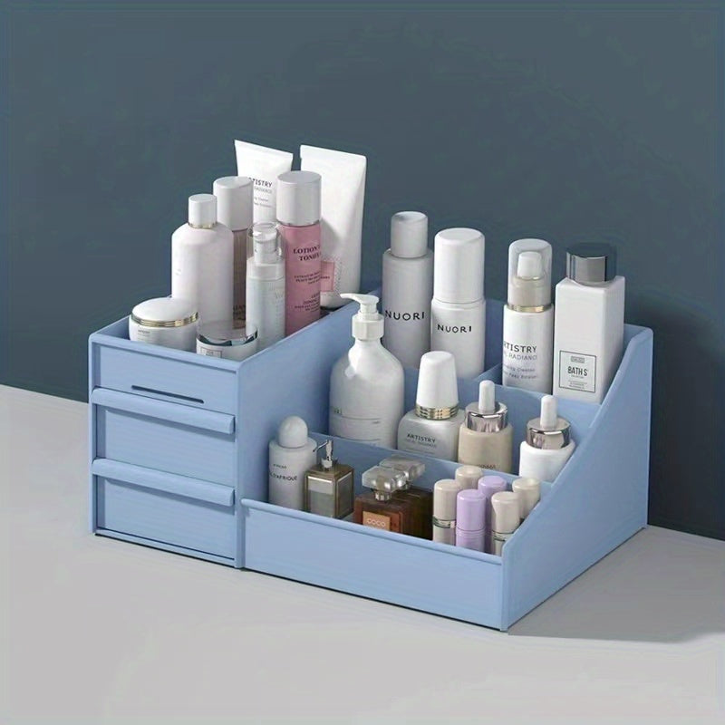 Blue cosmetic organizer with various skincare products on a gray surface and dark blue background