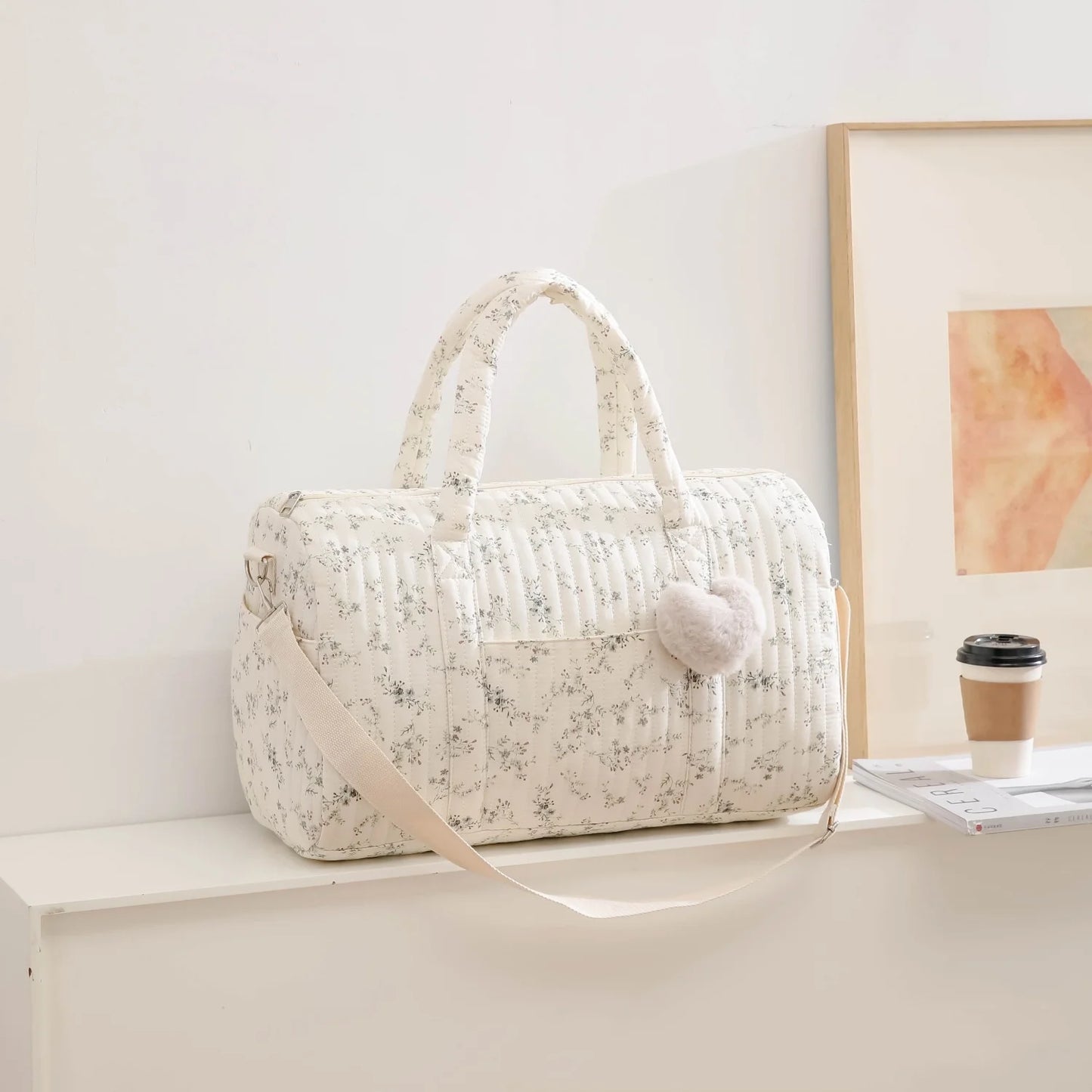Floral-patterned handbag on a white surface with a light background