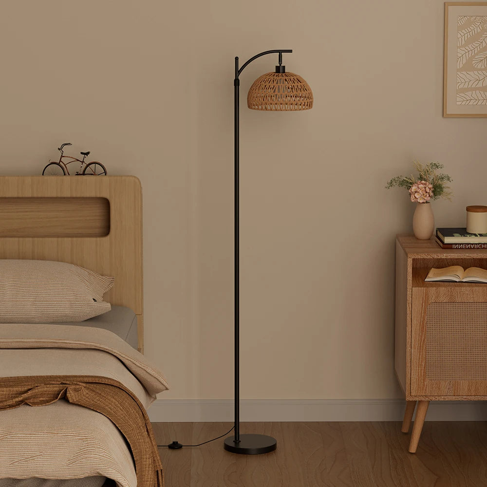 Modern bedroom with a floor lamp, bed, and side table.