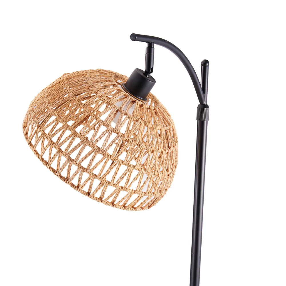 Floor lamp with a wicker shade and black metal arm on a white background