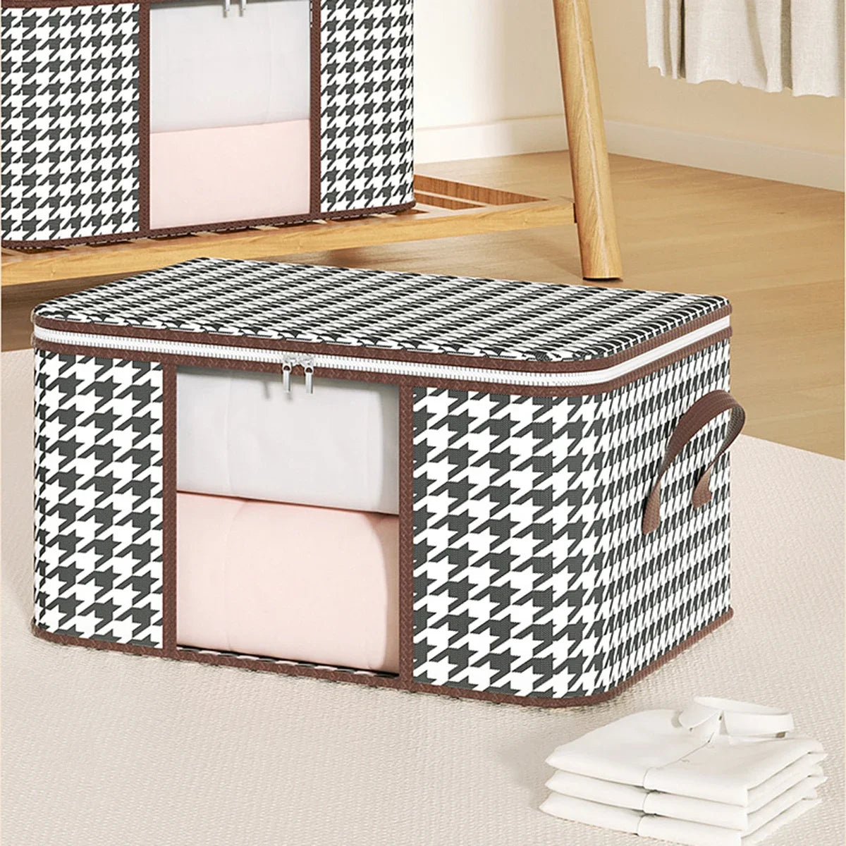 Houndstooth patterned storage box with a pink interior on a light wooden floor.