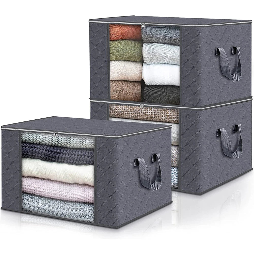Gray storage boxes with handles filled with folded clothes on a white background