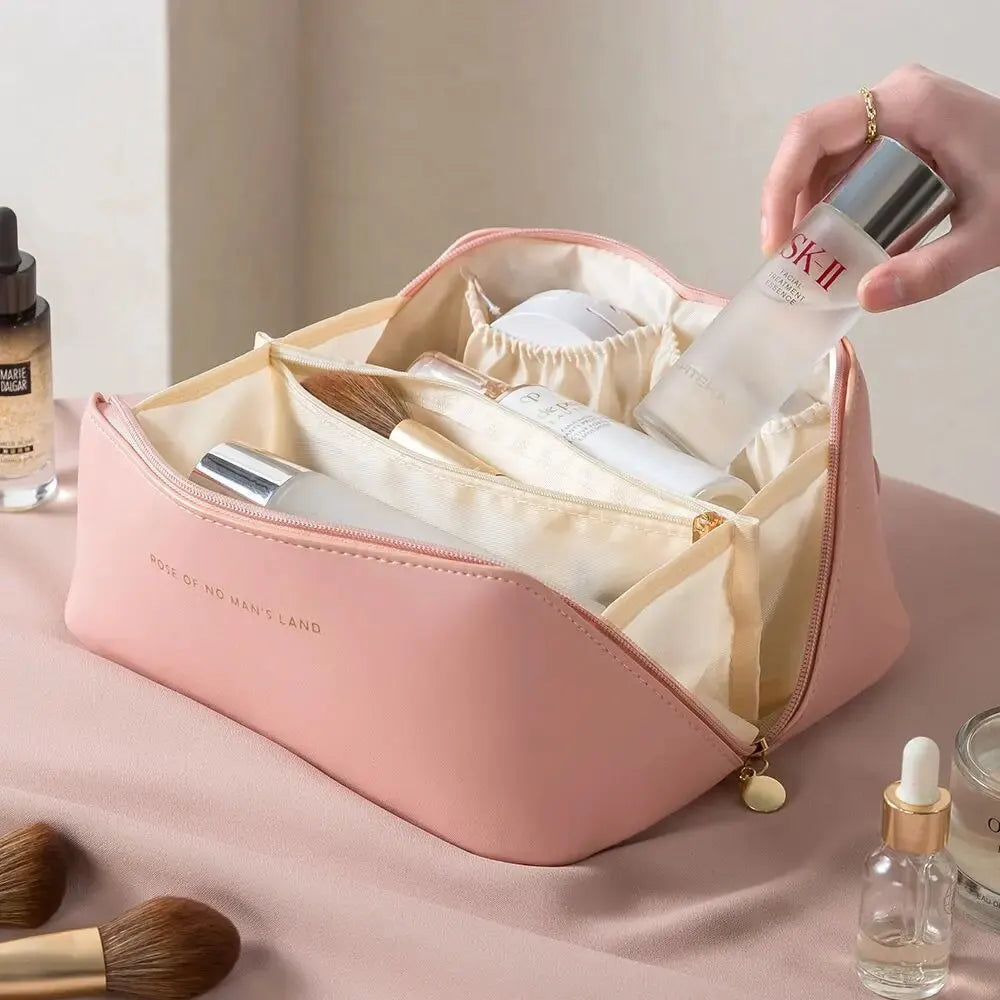 Pink cosmetic bag with skincare products on a beige background
