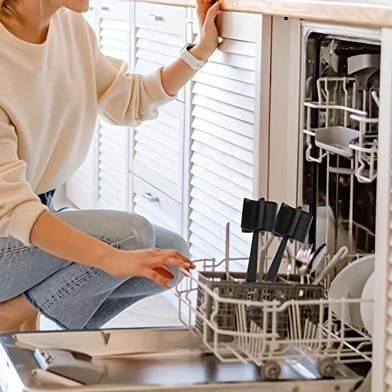 Person opening a dishwasher with dishes inside