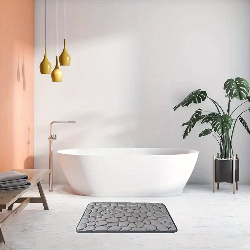 Modern bathroom with a freestanding bathtub, gray textured rug, and potted plant.