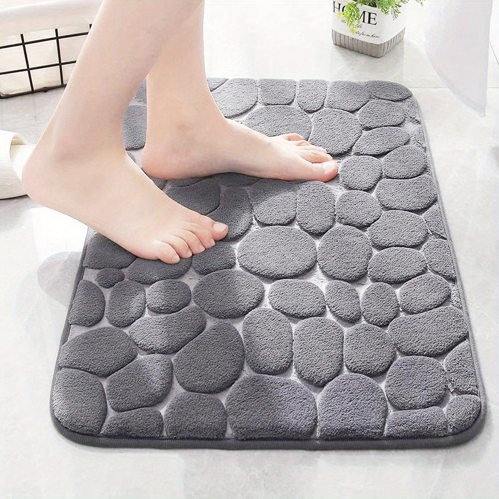 Gray stone-patterned bath mat with a person stepping onto it.