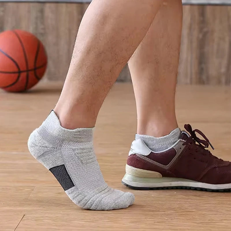 Person wearing gray ankle socks with a basketball in the background