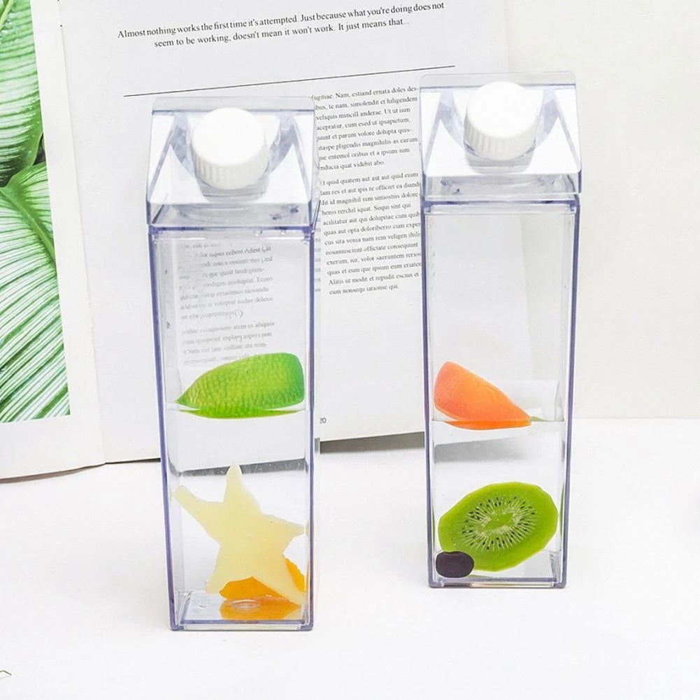 Two clear plastic containers with sliced kiwis and oranges on a white background