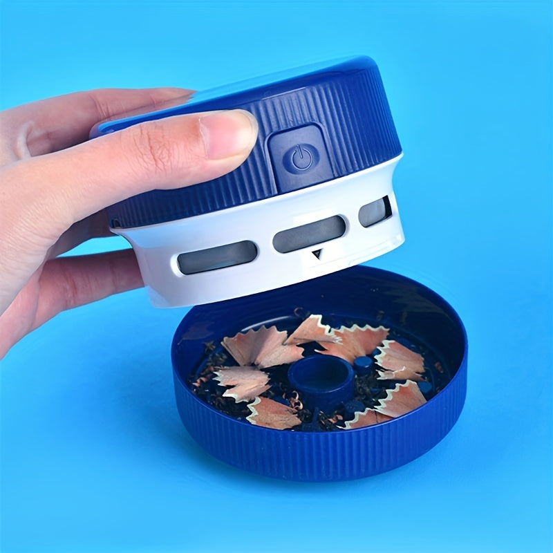 Hand holding a blue pencil sharpener with sharpened pencils inside on a blue background