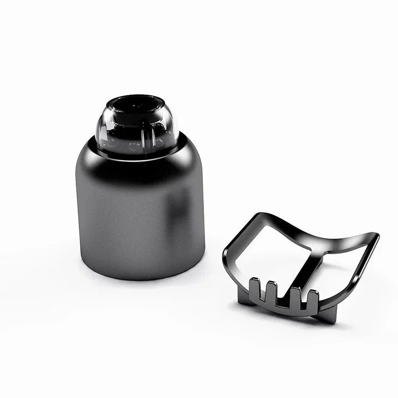 Black cylindrical object with a clear top and a metallic clip on a white background