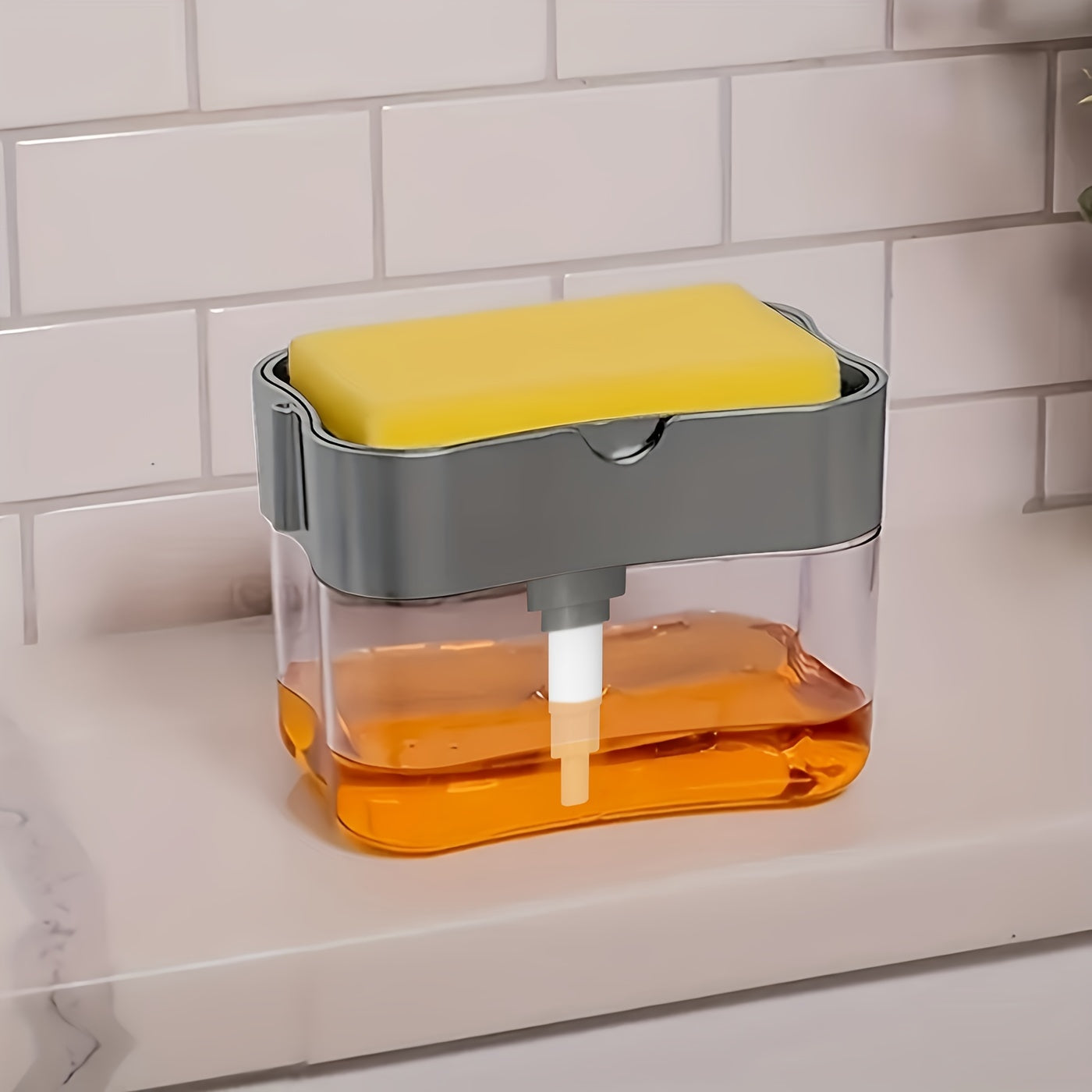 Container with a yellow sponge and orange liquid on a white tiled wall background