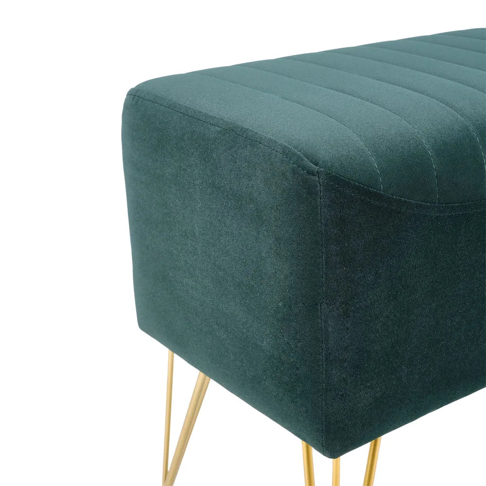 Green upholstered bench with gold legs on a white background