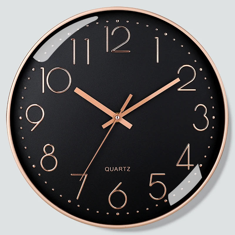 Wall clock with black face and rose gold hands on a light gray background