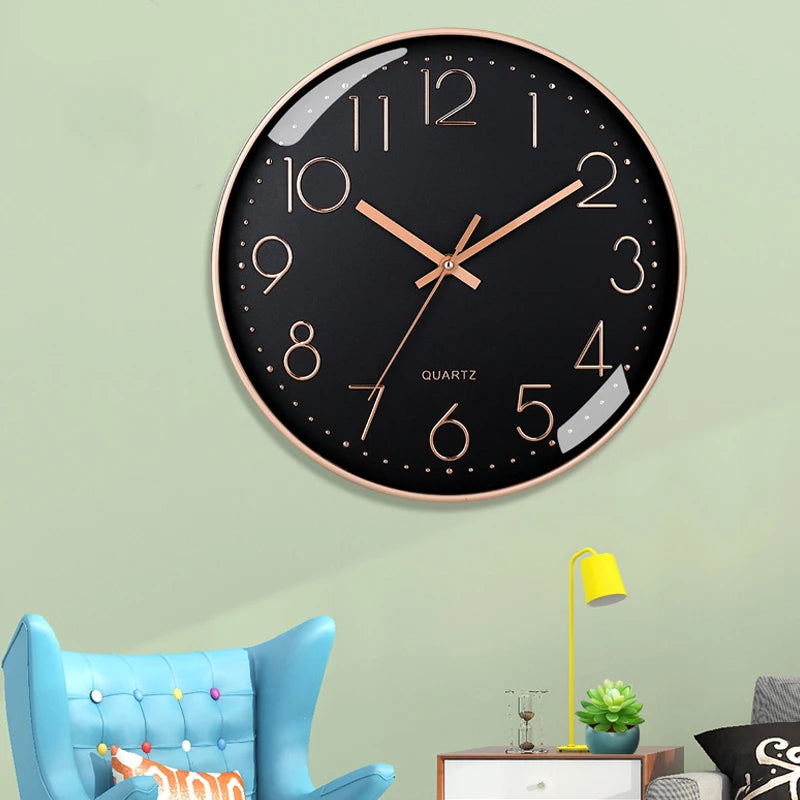 Wall clock with rose gold frame and black face on a light green wall.