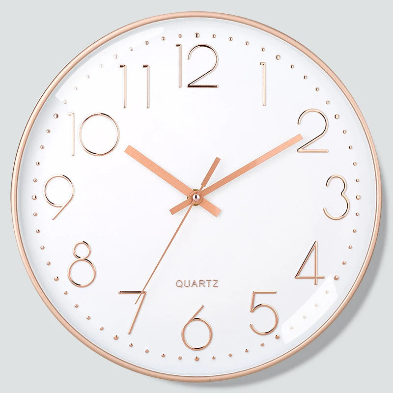 Wall clock with rose gold frame and numerals on a light gray background