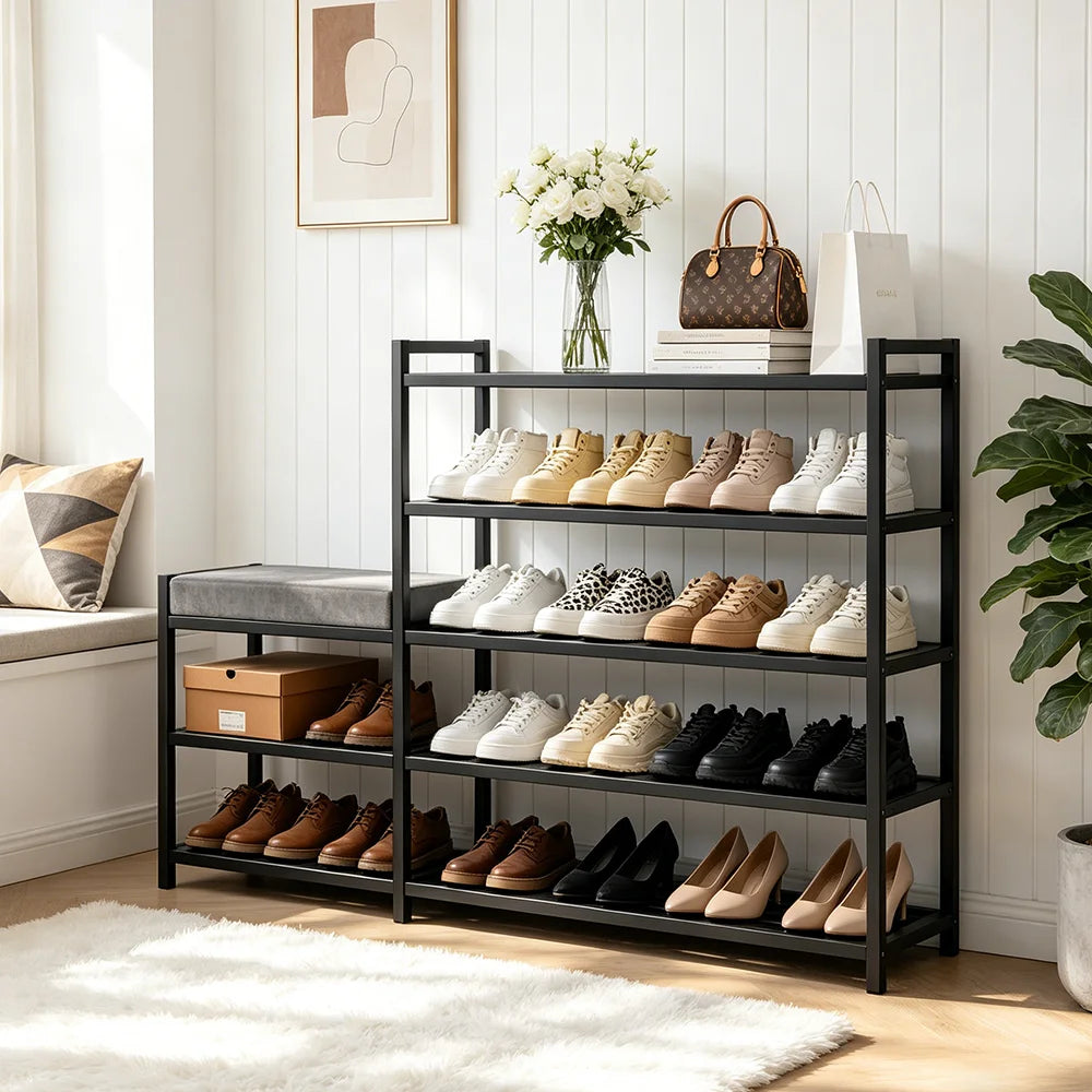 Black shoe rack with various shoes on shelves in a room with decor elements.