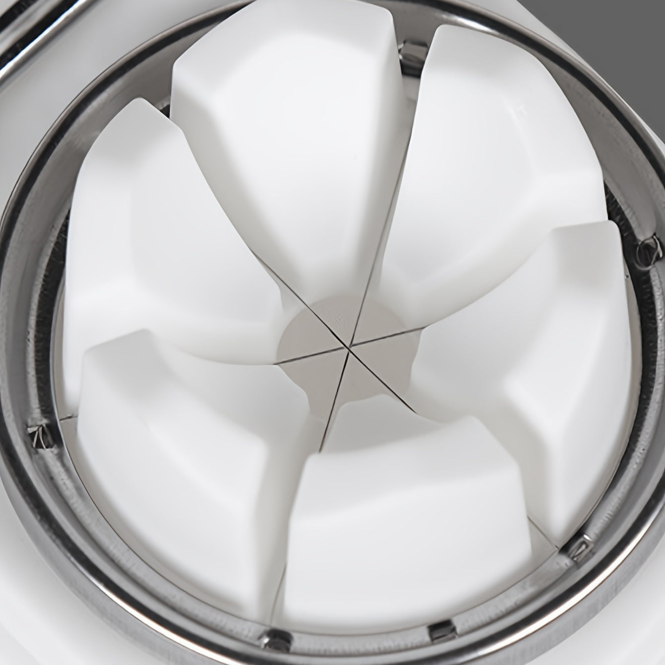 Close-up of a white wheel with a metallic rim on a gray background