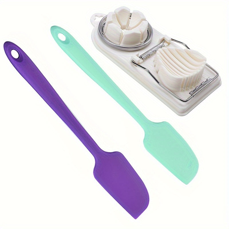 Set of kitchen tools including a purple spatula, green spatula, and a white cheese grater on a white background.