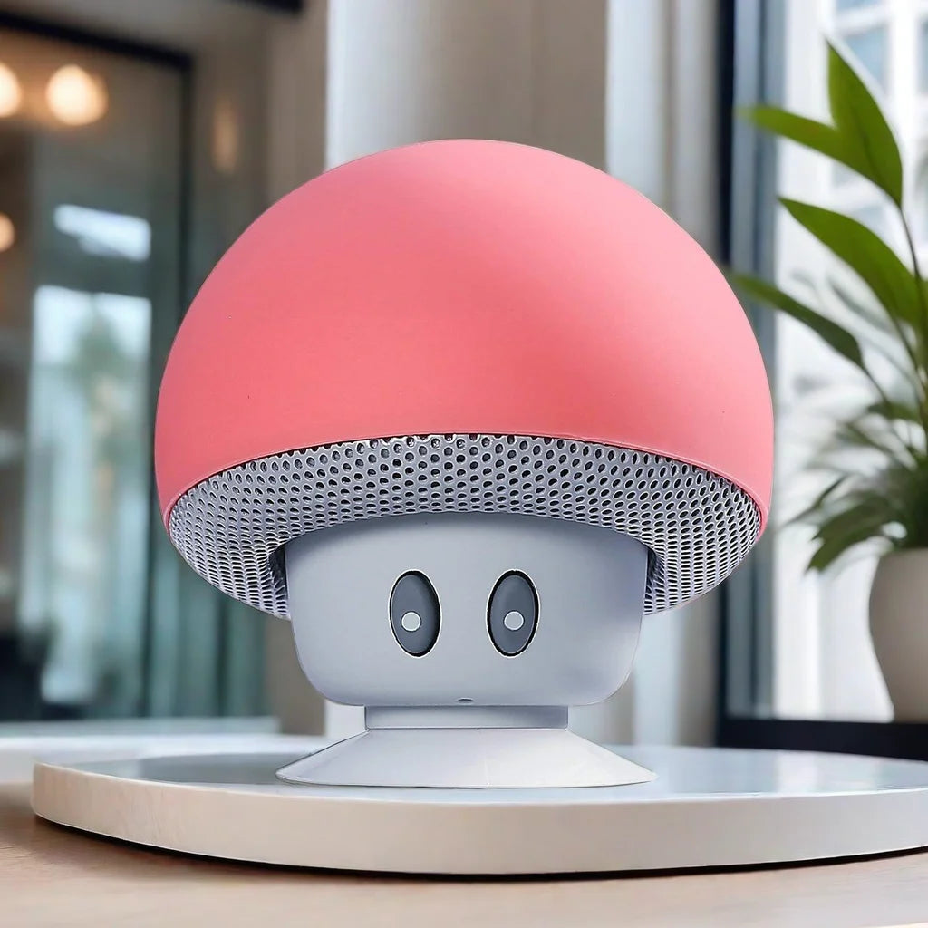 Pink and white mushroom-shaped speaker on a table with a blurred indoor background