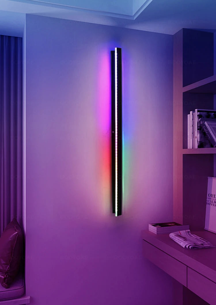 Colorful LED wall light fixture in a room with books and a shelf.