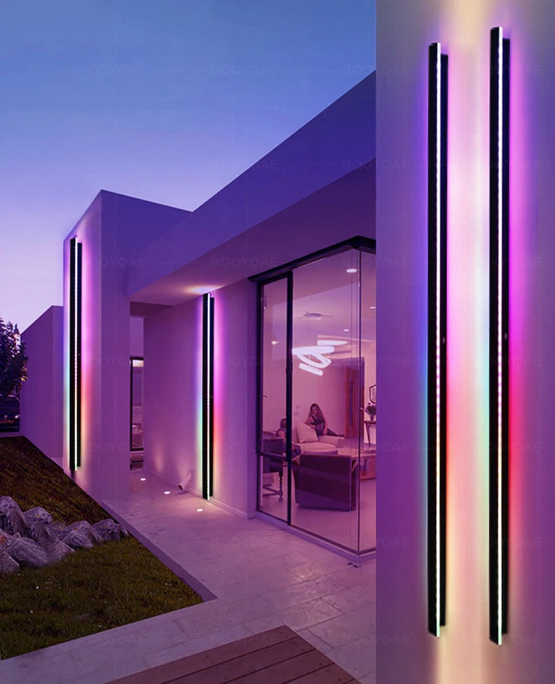 Modern house exterior with colorful light fixtures at dusk