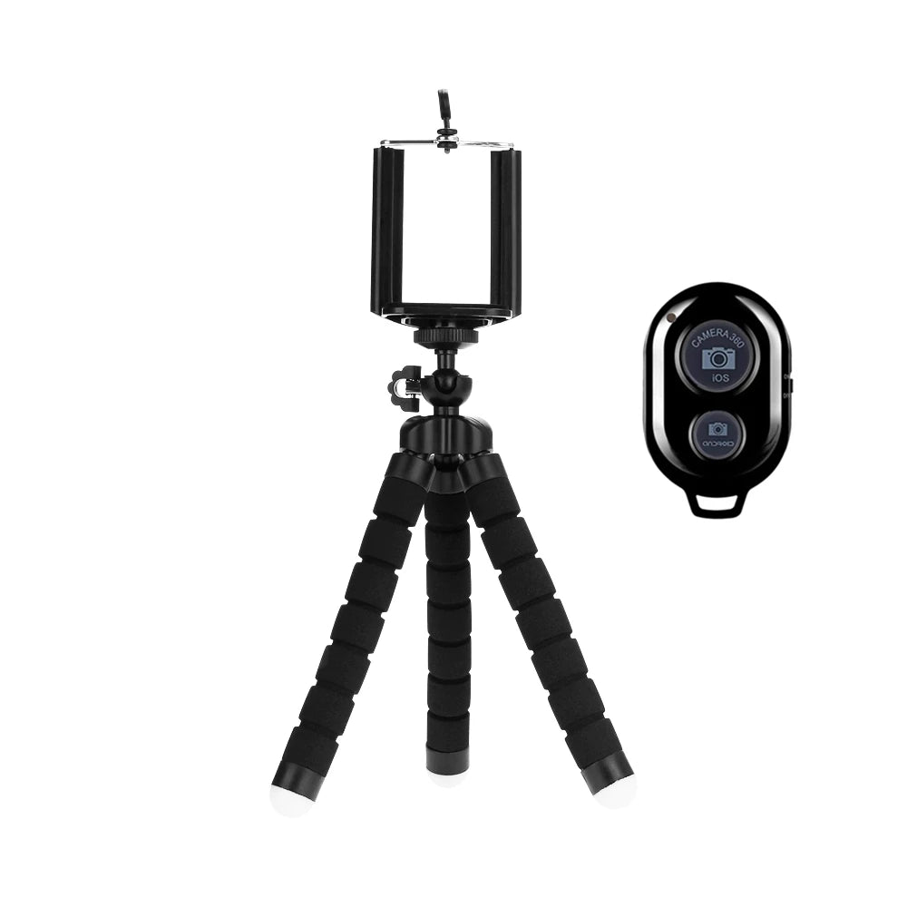 Black camera tripod with smartphone holder and remote control on a white background
