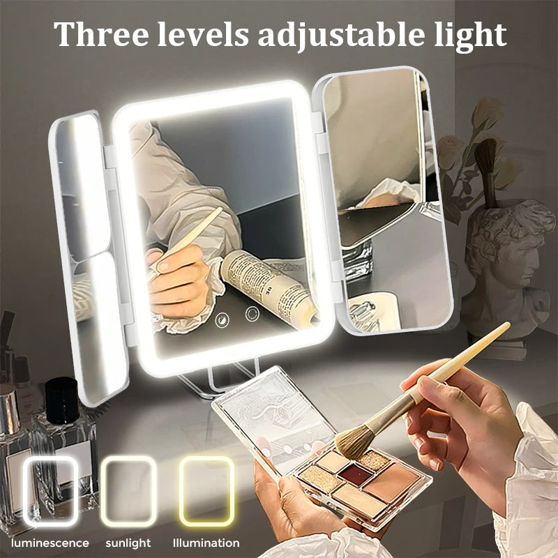Foldable light-up mirror with three adjustable light levels, used for makeup application.