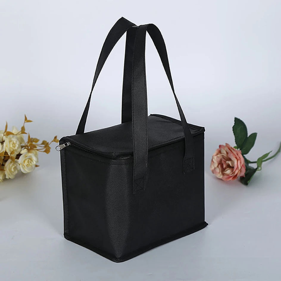 Black insulated lunch bag on a white background with flowers