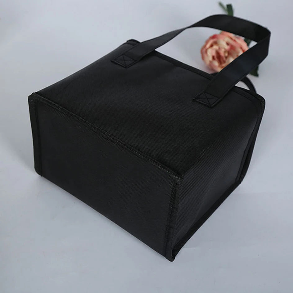 Black insulated lunch bag on a light gray background