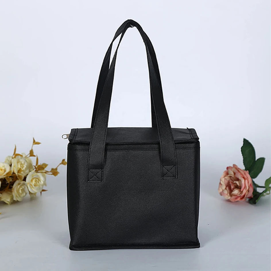 Black tote bag on a white background with flowers