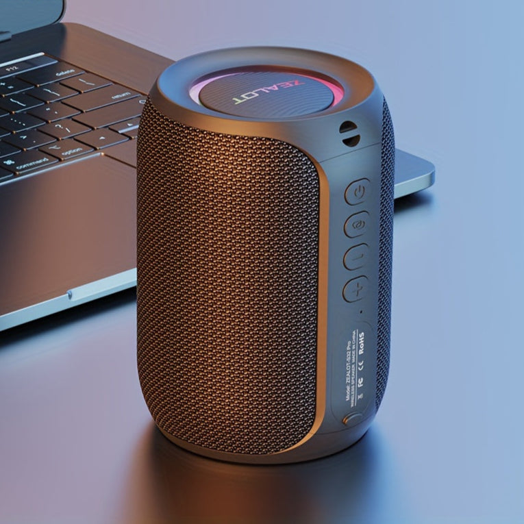 Portable speaker with brand logo on a laptop keyboard