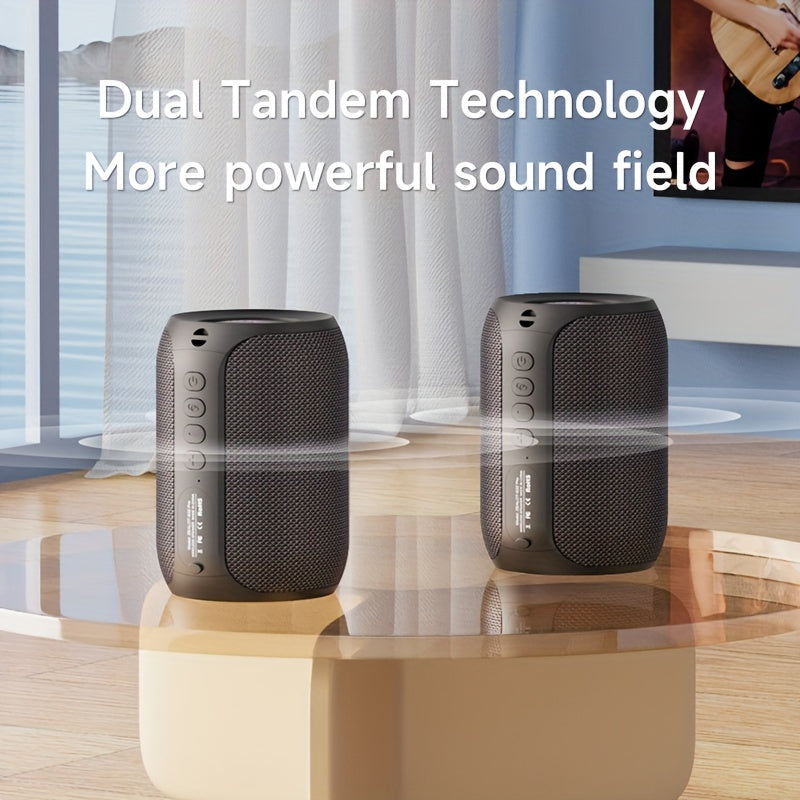 Two black speakers on a table with text about dual tandem technology in a room setting.