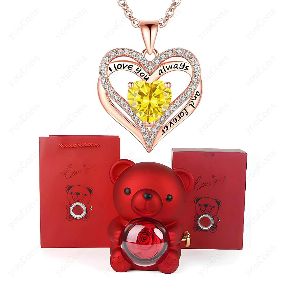 Heart-shaped necklace with yellow gem and rose, red teddy bear with rose, and red box on white background