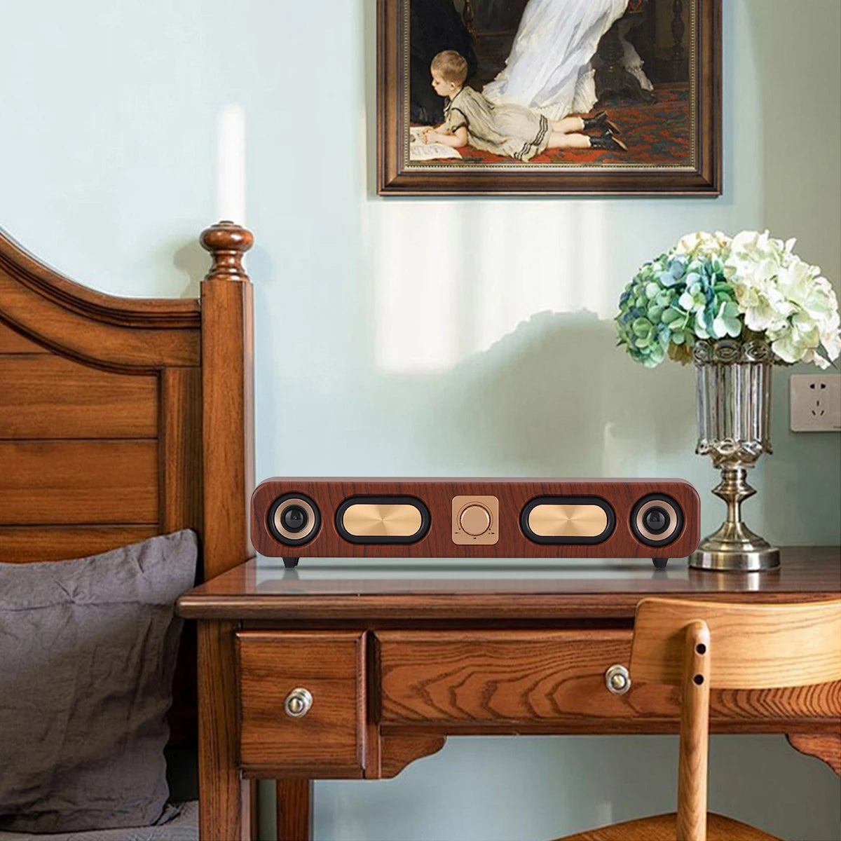 Wooden nightstand with decorative items including a lamp and flowers, with a painting on the wall.