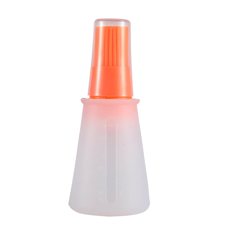 White spray bottle with an orange nozzle on a white background