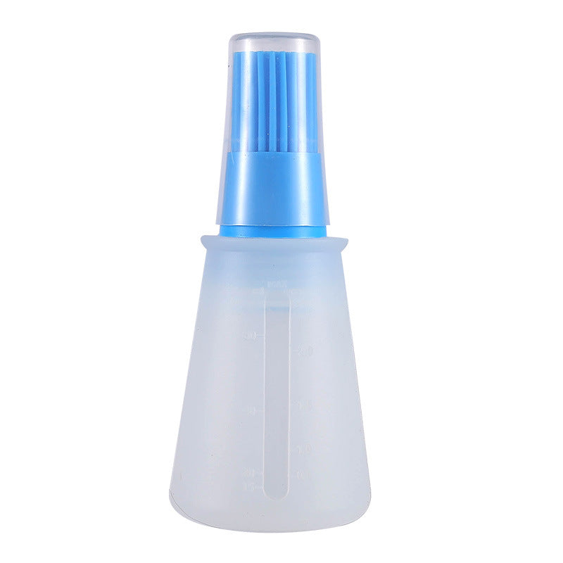 Transparent spray bottle with blue nozzle on a white background
