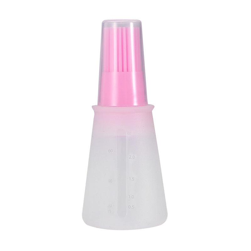 Transparent spray bottle with pink top on a white background