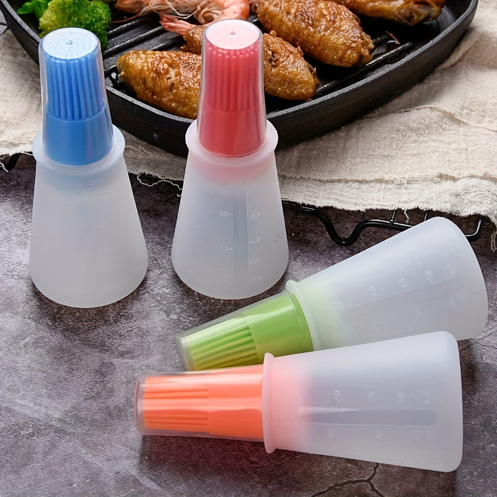 Set of silicone basting brushes with colored handles on a stone surface.