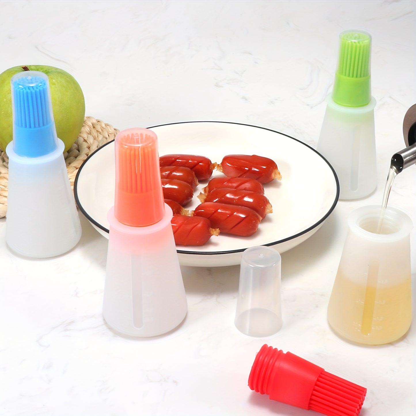 silicone basting brushes with different colored ends on a white background