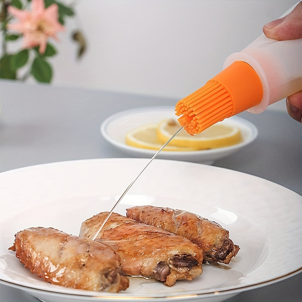 Person using a silicone brush to drizzle oil on roasted chicken wings with a blurred background.