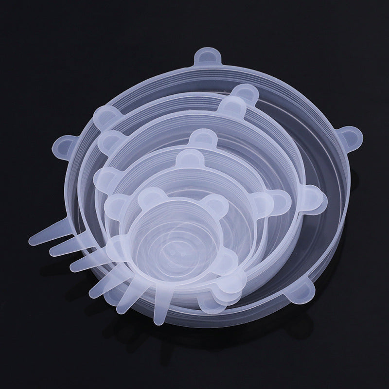 Stack of clear silicone lids on a black background