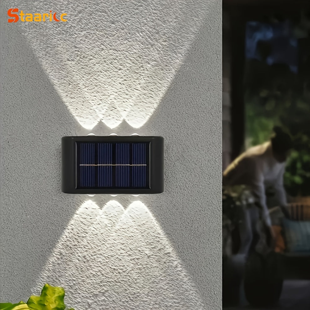 Solar wall light fixture on a textured wall with a blurred outdoor background.