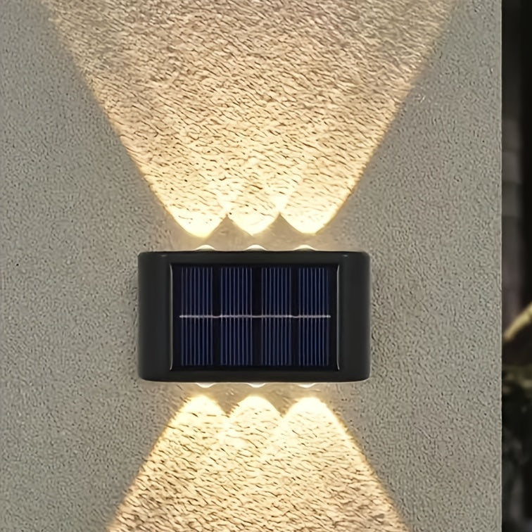 Solar-powered outdoor wall light fixture on a textured wall