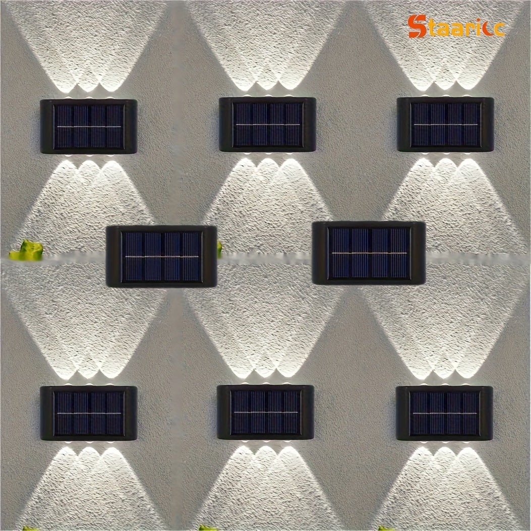 Solar lights mounted on a textured wall with 'Staark' branding.