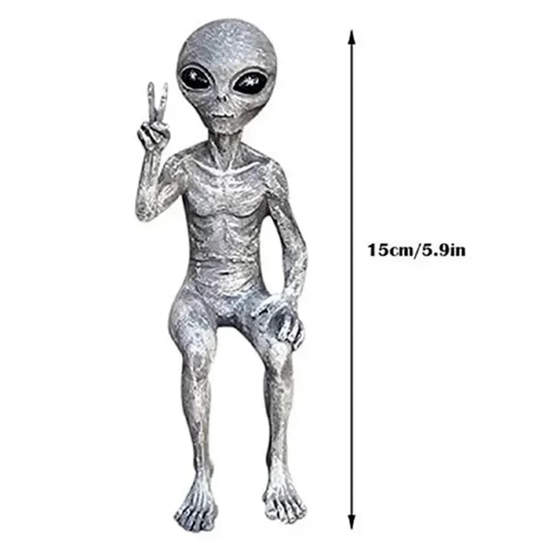 Silver alien figure making a peace sign with dimensions indicated on a white background