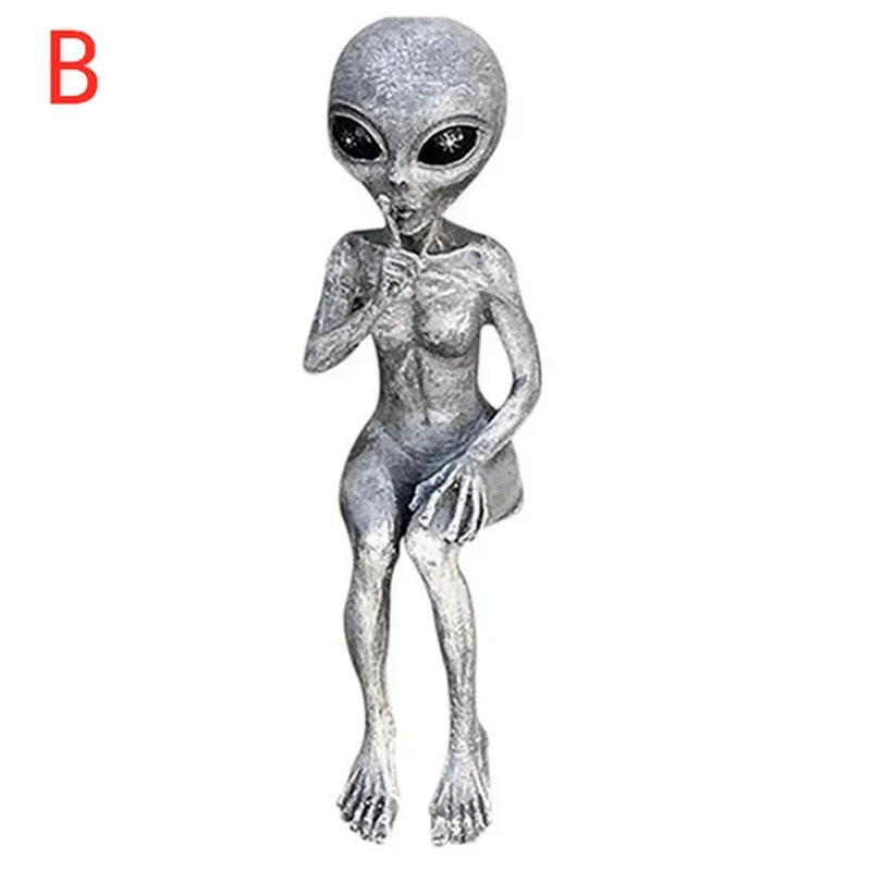 Silver alien figurine on a white background