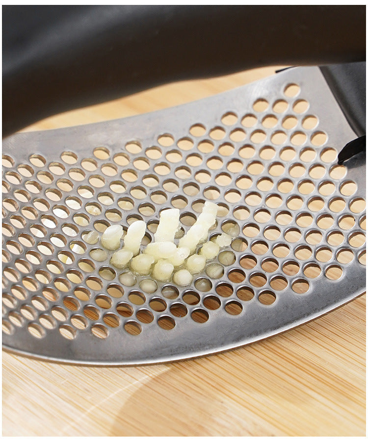 Metal grater with holes on a wooden surface